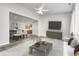 Open-concept living room with modern decor, hardwood floors, and a seamless flow into the dining area and kitchen at 6816 Park Square Dr # C, Avon, IN 46123