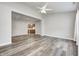 Open-concept living room with hardwood floors flowing into adjacent kitchen area at 6816 Park Square Dr # C, Avon, IN 46123