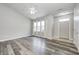 Bright living room featuring hardwood floors, large windows, and modern ceiling fan at 6816 Park Square Dr # C, Avon, IN 46123