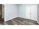 Neutral room featuring gray walls, wood-look floors, closet and a doorway at 6816 Park Square Dr # C, Avon, IN 46123