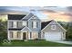 Charming two-story home with a mix of siding, shutters, and a well-manicured lawn at 700 North W, McCordsville, IN 46055