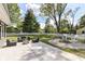 Beautiful backyard with a concrete patio, fire pit, and a white picket fence at 7118 Mikesell Dr, Indianapolis, IN 46260