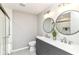 Modern bathroom with dual vanity, sleek fixtures, and a glass-enclosed shower at 7118 Mikesell Dr, Indianapolis, IN 46260