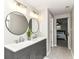 Stylish bathroom with dual sinks, modern lighting, and access to the primary bedroom at 7118 Mikesell Dr, Indianapolis, IN 46260