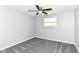Bright bedroom with gray carpet, ceiling fan, and window providing natural light at 7118 Mikesell Dr, Indianapolis, IN 46260