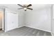 Bedroom features modern ceiling fan, soft gray carpet and a large closet for storage at 7118 Mikesell Dr, Indianapolis, IN 46260