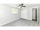 Cozy bedroom with gray carpet, window, ceiling fan, and a spacious closet at 7118 Mikesell Dr, Indianapolis, IN 46260