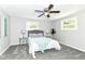 Charming bedroom with soft carpet, ceiling fan, and an inviting queen-sized bed at 7118 Mikesell Dr, Indianapolis, IN 46260