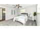 Well lit bedroom with soft carpet, stylish decor, and a ceiling fan at 7118 Mikesell Dr, Indianapolis, IN 46260