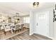 Open-concept dining area featuring modern lighting, wood-look floors, and seamless access to the kitchen at 7118 Mikesell Dr, Indianapolis, IN 46260