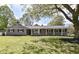 Charming single-story home with manicured front lawn and lovely curb appeal at 7118 Mikesell Dr, Indianapolis, IN 46260