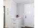 Kitchen area with a white door to the outside and modern cabinets at 7118 Mikesell Dr, Indianapolis, IN 46260