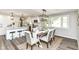 Beautiful open-concept kitchen with white cabinetry, a large island, and stainless steel appliances at 7118 Mikesell Dr, Indianapolis, IN 46260