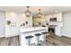 Open-concept kitchen boasts white cabinets, quartz countertops, and stainless steel appliances at 7118 Mikesell Dr, Indianapolis, IN 46260