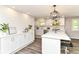 Bright white kitchen features quartz countertops, stainless appliances, and a stylish design at 7118 Mikesell Dr, Indianapolis, IN 46260