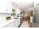 Bright kitchen featuring white cabinetry, stainless steel appliances, and modern fixtures at 7118 Mikesell Dr, Indianapolis, IN 46260