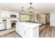 Open kitchen with white cabinets, stainless steel appliances, and view of dining area at 7118 Mikesell Dr, Indianapolis, IN 46260