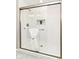 Modern bathroom shower with glass enclosure, white tile and a built in niche with greenery at 7118 Mikesell Dr, Indianapolis, IN 46260