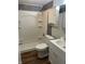 Modern bathroom with white fixtures, updated shower and grey marble accent wall at 7131 E 14Th St, Indianapolis, IN 46219