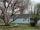 Quaint home with blooming magnolia tree and well-kept front yard showcasing its curb appeal at 7131 E 14Th St, Indianapolis, IN 46219