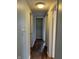 Hallway showcasing wood floors leading to multiple rooms, closets, and overhead lighting at 7131 E 14Th St, Indianapolis, IN 46219