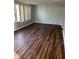 Inviting living room features wood floors and large windows with neutral walls at 7131 E 14Th St, Indianapolis, IN 46219