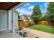 View of a back porch leading to a yard that features artificial turf and a privacy fence at 7614 Bishops, Zionsville, IN 46077