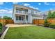 A two-story home featuring artificial turf, a fenced yard, and a second story porch at 7614 Bishops, Zionsville, IN 46077