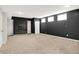 Spacious basement features black accent wall and light-colored carpeting at 7614 Bishops, Zionsville, IN 46077