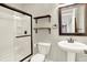 Bathroom featuring walk in shower, white fixtures, and floating shelves at 7614 Bishops, Zionsville, IN 46077
