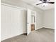 Bedroom showcasing a ceiling fan and a view into the hall at 7614 Bishops, Zionsville, IN 46077