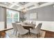Elegant dining room with coffered ceilings, a stylish chandelier, and ample seating for six at 7614 Bishops, Zionsville, IN 46077