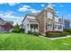 Landscaped lawn and plantings compliment the exterior of this two-story home with a stone facade and inviting front porch at 7614 Bishops, Zionsville, IN 46077