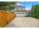 View of a two-story home featuring a garage, a long driveway, and mature landscaping at 7614 Bishops, Zionsville, IN 46077