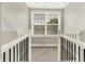 Bright hallway nook area with large window, natural light and neutral carpet creating a cozy space at 7614 Bishops, Zionsville, IN 46077