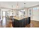 Spacious kitchen with white cabinets, a center island, granite countertops and hardwood floors at 7614 Bishops, Zionsville, IN 46077