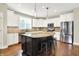 This kitchen features white cabinets, stainless steel appliances, a center island and dark hardwood flooring at 7614 Bishops, Zionsville, IN 46077
