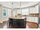 A kitchen with white cabinets, a center island with seating and hardwood floors at 7614 Bishops, Zionsville, IN 46077