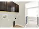 Laundry room with overhead cabinets and hookups providing a functional space for laundry tasks at 7614 Bishops, Zionsville, IN 46077