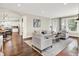 Open-concept living room with hardwood floors and natural light, flowing into the kitchen at 7614 Bishops, Zionsville, IN 46077