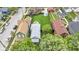 Overhead view of a home and its long yard with green grass and a firepit, surrounded by neighborhood houses and cars at 767 Fletcher Ave, Indianapolis, IN 46203
