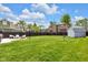 Expansive backyard featuring a well-manicured lawn, privacy fence, fire pit, hot tub, and storage shed at 767 Fletcher Ave, Indianapolis, IN 46203