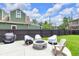 Backyard features a stone fire pit, outdoor furniture, and well-maintained lawn at 767 Fletcher Ave, Indianapolis, IN 46203