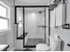 Modern bathroom featuring a black framed glass-enclosed shower, white towels and patterned floor tiles at 767 Fletcher Ave, Indianapolis, IN 46203
