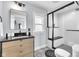 Bathroom featuring a vanity with black countertop, a glass-enclosed shower and patterned floor tiles at 767 Fletcher Ave, Indianapolis, IN 46203