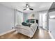 Well-lit bedroom featuring a queen bed, pillows, artwork and a ceiling fan at 767 Fletcher Ave, Indianapolis, IN 46203
