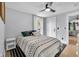 Comfortable bedroom featuring a patterned duvet, pillows and a black ceiling fan at 767 Fletcher Ave, Indianapolis, IN 46203