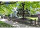 Lovely home exterior with a lush green lawn, fence, and mature shade tree at 767 Fletcher Ave, Indianapolis, IN 46203