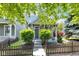 Charming home with manicured landscaping, picket fence, and covered front porch at 767 Fletcher Ave, Indianapolis, IN 46203