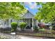 Charming home with manicured landscaping, picket fence, and covered front porch at 767 Fletcher Ave, Indianapolis, IN 46203
